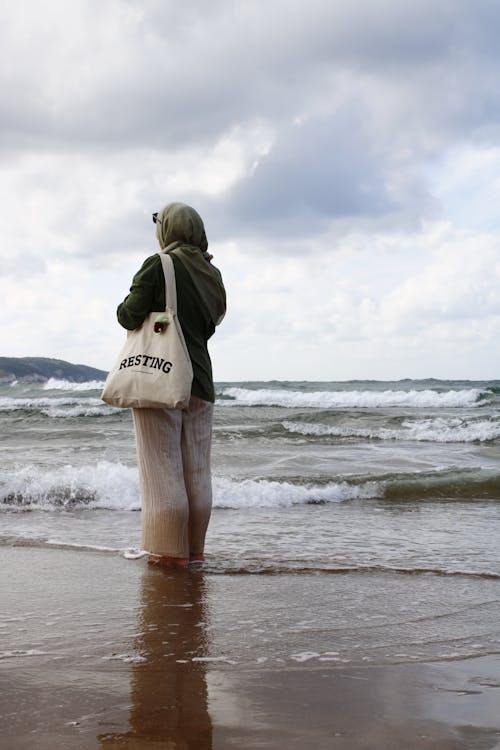 Woman in Hijab Standing on Sea Shore