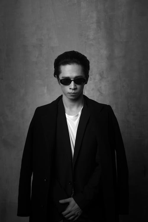 Free Model Posing in Jacket and Sunglasses in Black and White Stock Photo