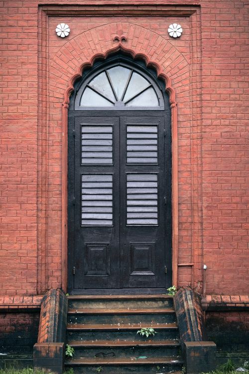 Free Elegant black arched door in a red brick wall, Dhaka, Bangladesh. Stock Photo