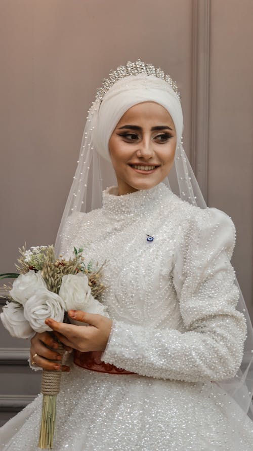 Smiling Bride in Wedding Dress and with Flowers Bouquet