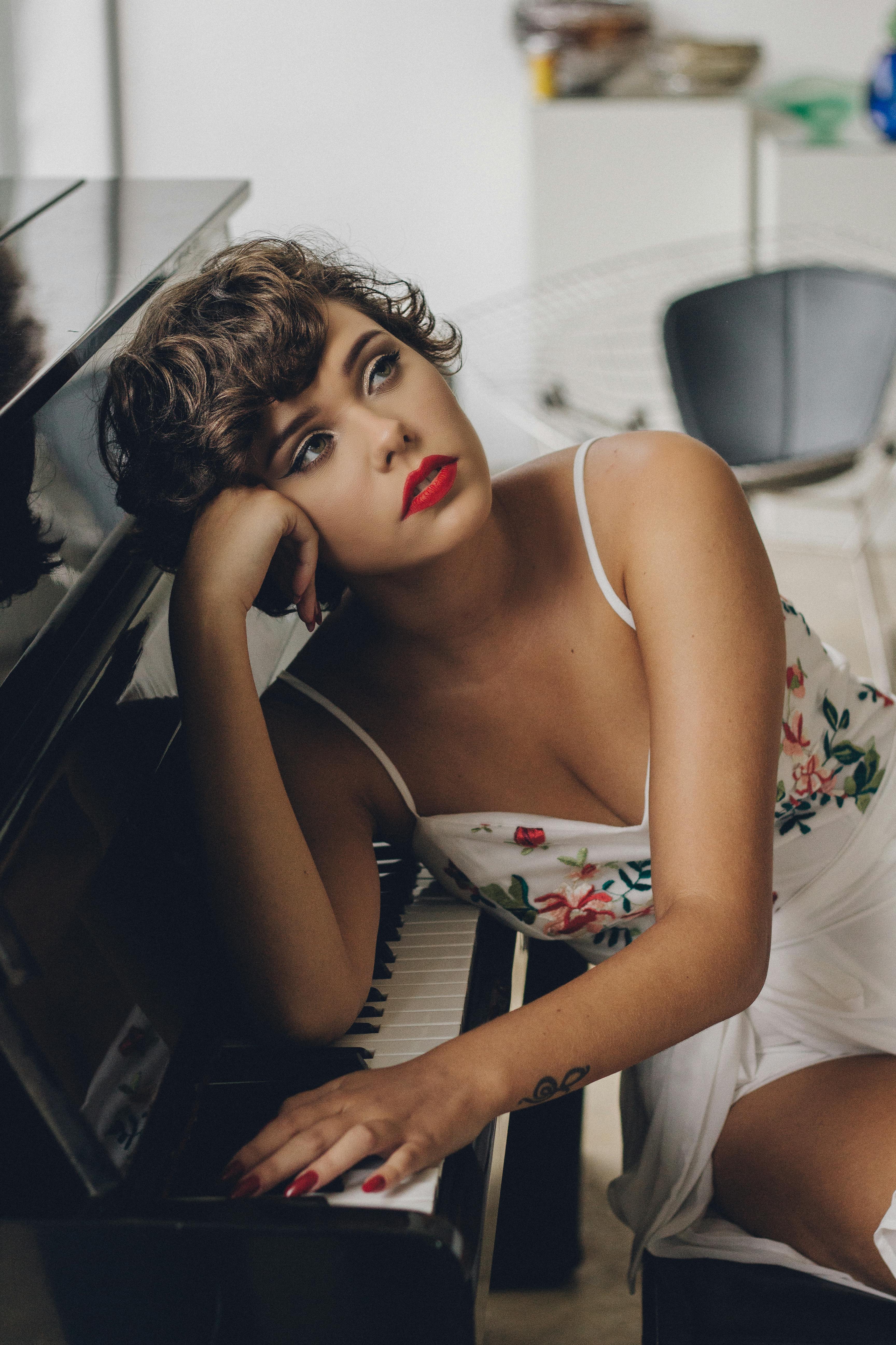 woman leaning on piano