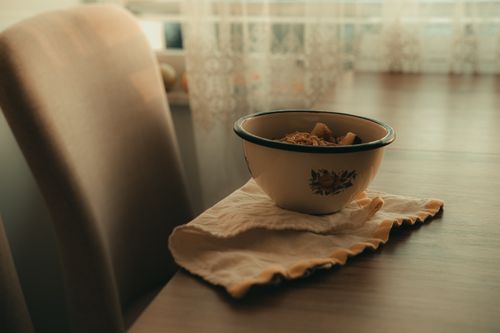 Free A vintage bowl filled with breakfast cereal on a table in warm sunlight. Stock Photo