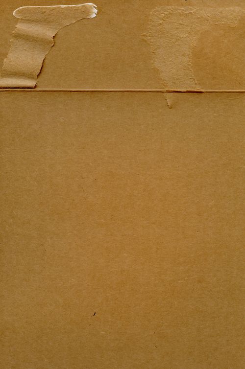 Free A close-up shot of a textured brown cardboard surface, ideal for backgrounds. Stock Photo