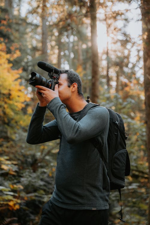 Man Making a Movie in a Forest