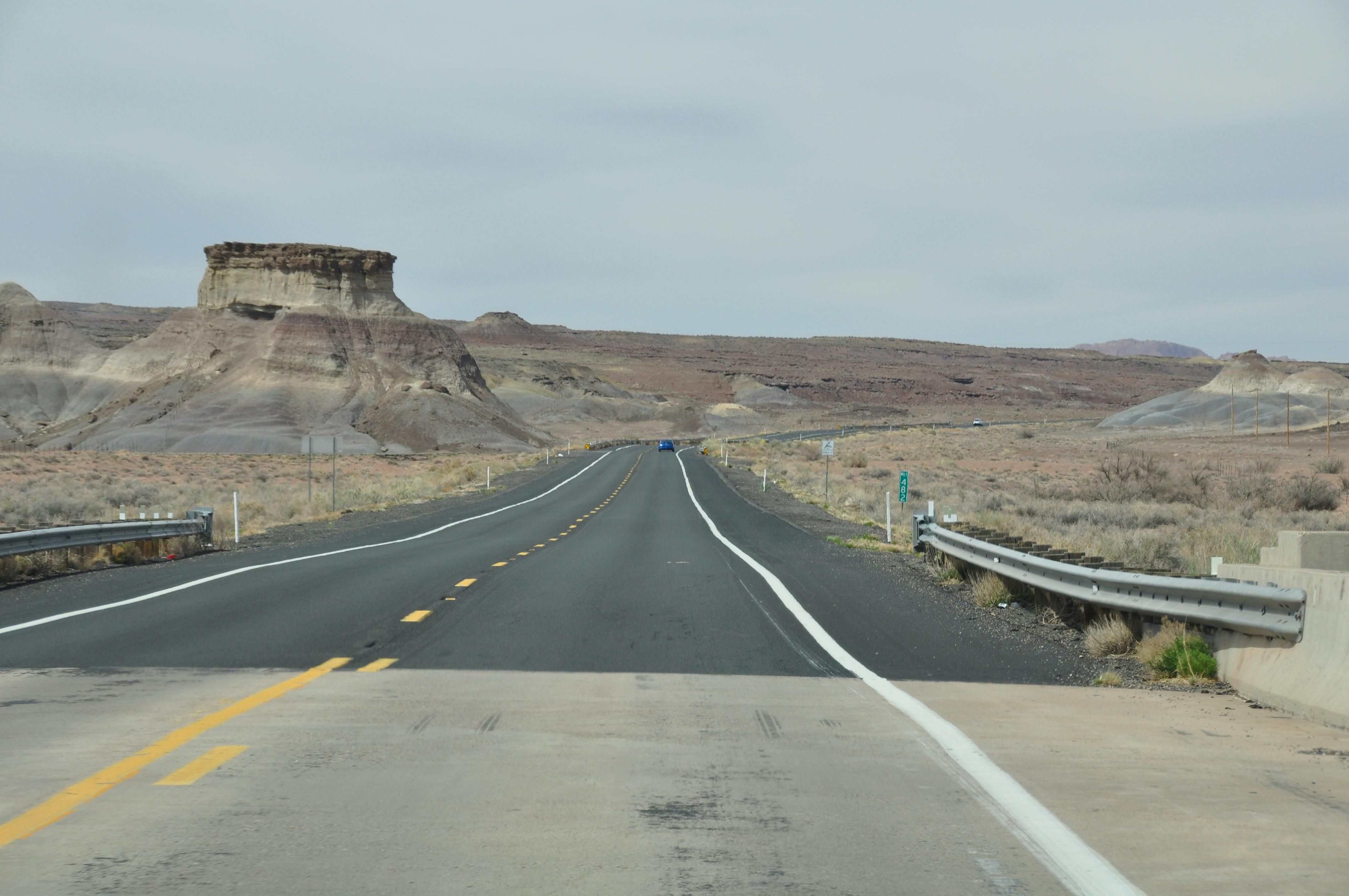 Gray Asphalt Road Between Green Grass Covered Mountains Under Blue Sky ...