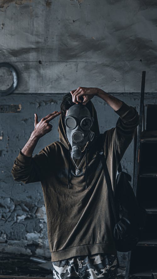 Man in Hoodie and in Gas Mask