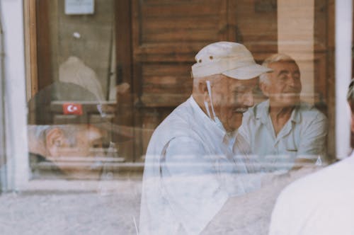 Elderly Men behind the Window 