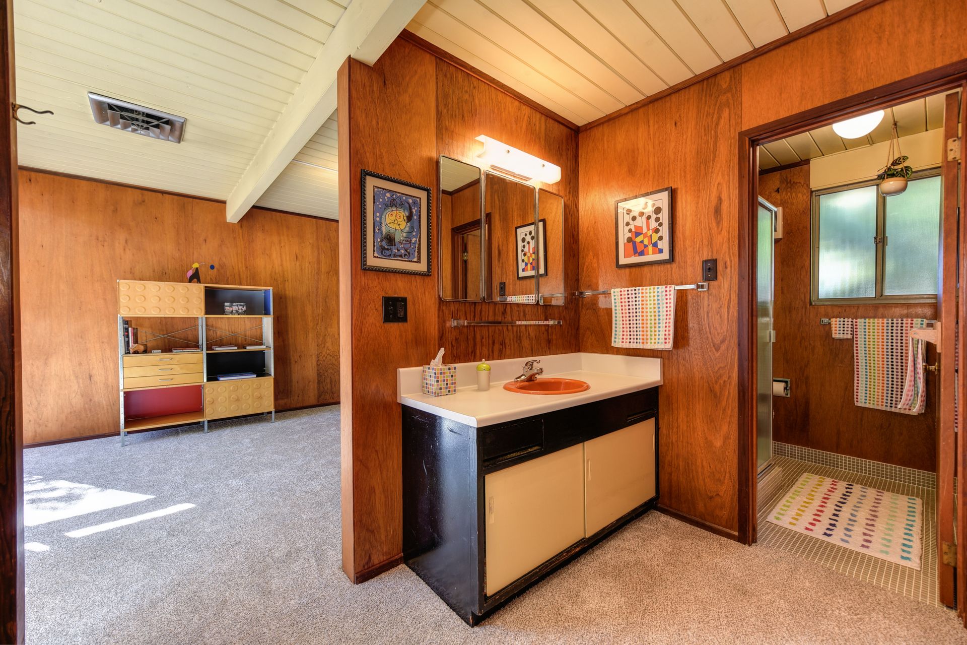 Bright mid-century modern bathroom with vintage design and wood paneling.