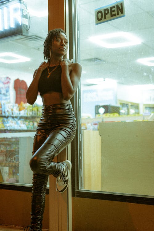 Woman Wearing Leather Pants Leaning on a Table · Free Stock Photo