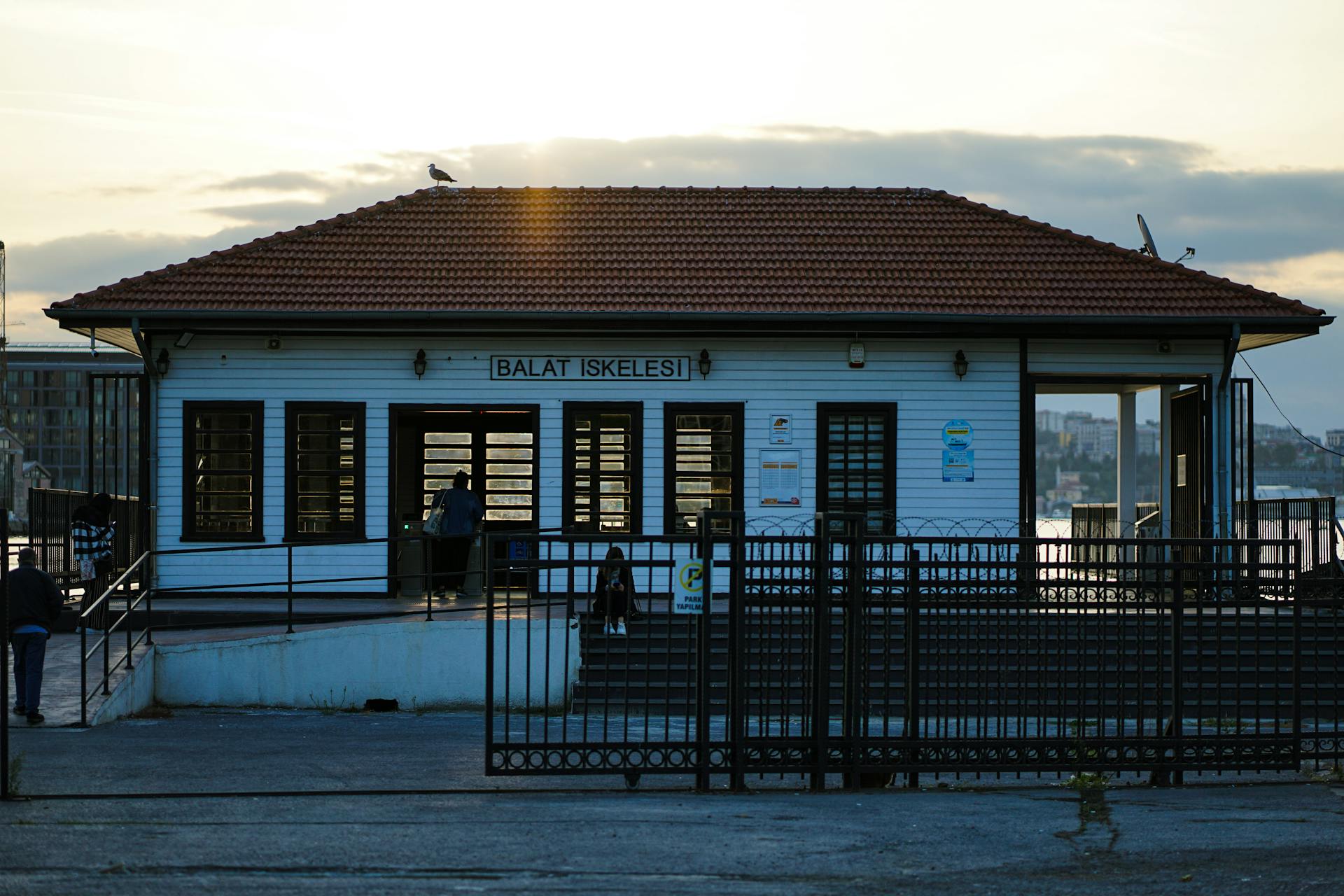 Balat Pier at sunset with city skyline and ferry terminal in Istanbul, Turkey.