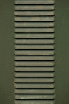 Detailed close-up image of a vertical metal vent with texture.