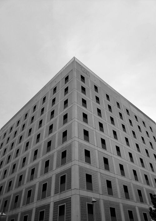 Free Black and white photo of a symmetrical urban building with windows. Stock Photo