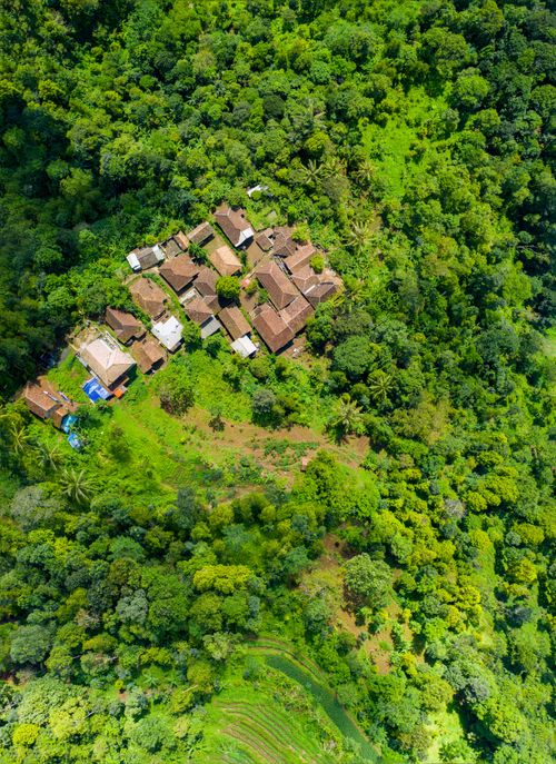 Free Captivating aerial view of a rural village nestled amidst lush green forests in Majasari, Banten, Indonesia. Stock Photo