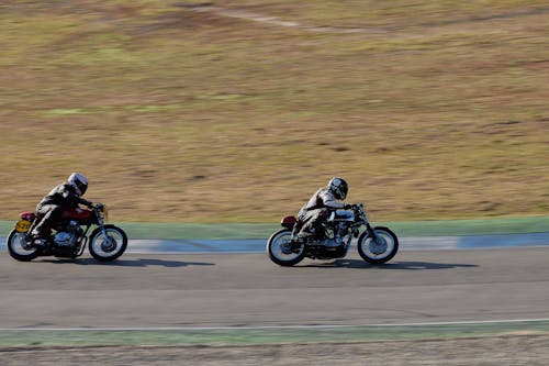 Riders on Motorbikes Riding on Circuit