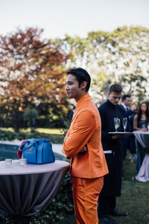 Man in Orange Suit at Party