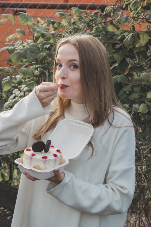 Portrait of Woman Eating Cake