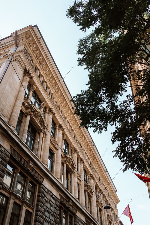 Free Upward view of historic Salt Galata facade in Istanbul lined with trees. Stock Photo