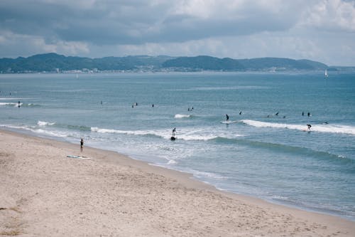 People Surfing in Sea