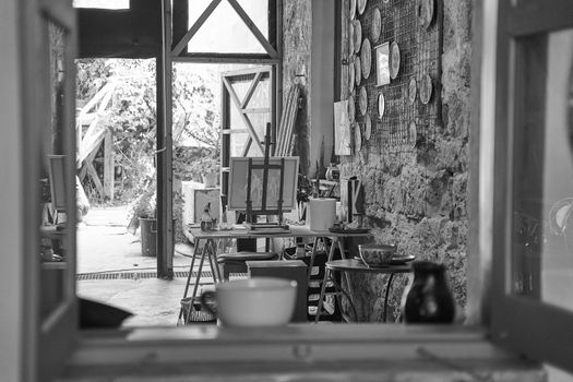 A detailed view of an artist's workshop with easels and paintings in Paphos, Cyprus.