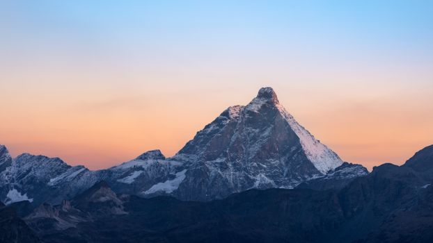 Captivating view of the Matterhorn at sunrise, showcasing vibrant colors and majestic peaks.