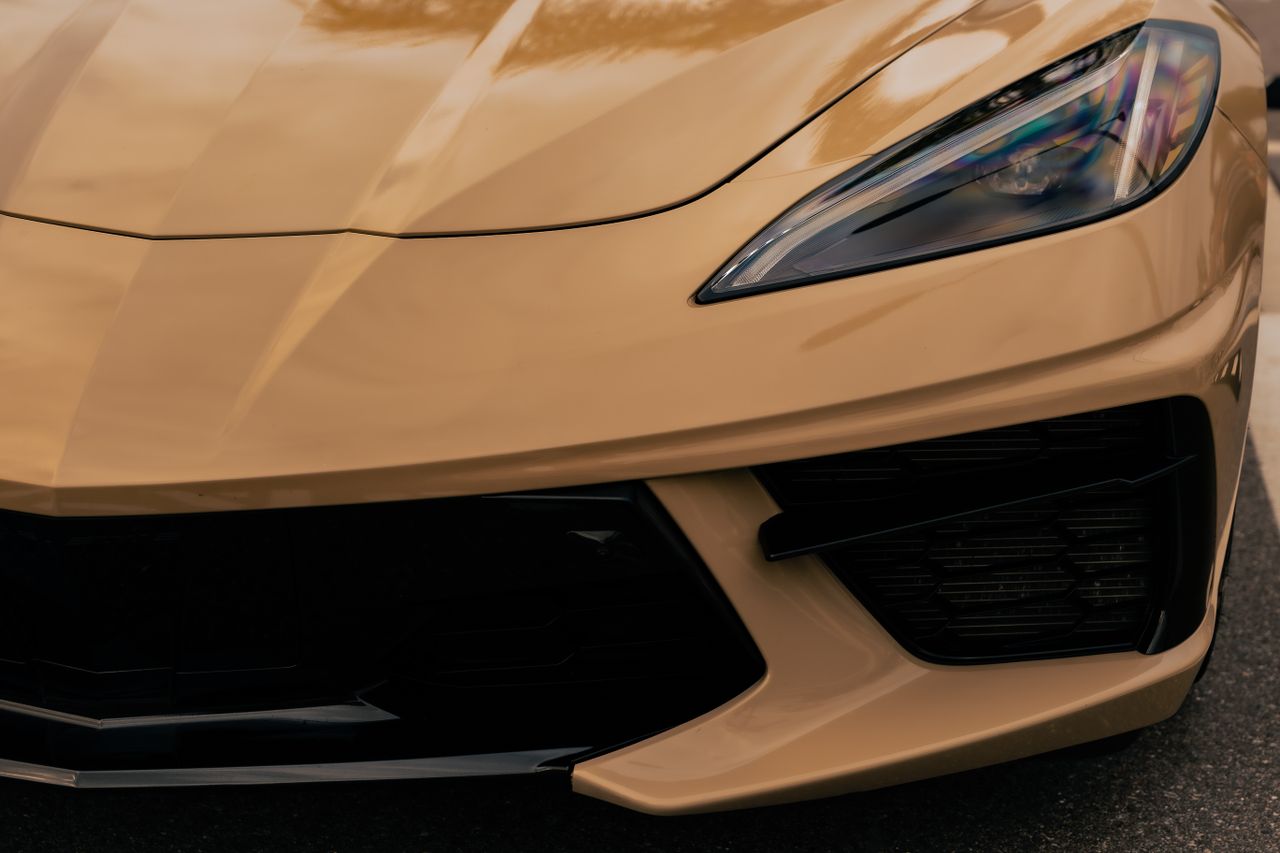detailed close up of a luxury sports car s front in metallic gold high