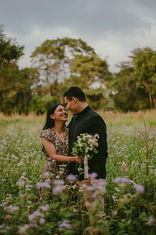 A Couple Hugging on a Grass Field 