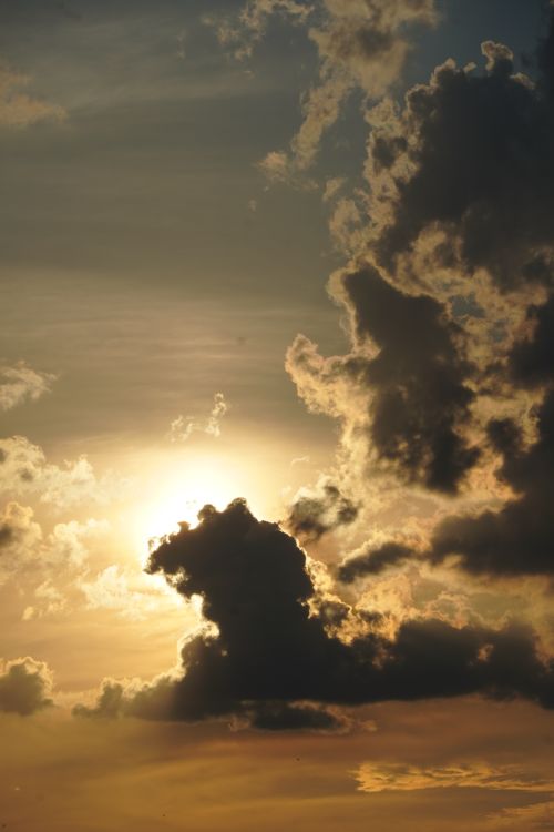 Free Captivating image of dramatic clouds against a stunning sunset sky, emitting a warm glow. Stock Photo