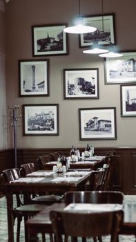 Vintage restaurant interior with framed historical photos and wooden tables.