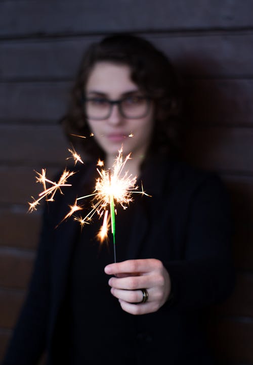 Free Woman Standing and Holding Sparkle Stock Photo