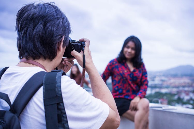 Man Taking A Picture Of A Woman On A View Point 