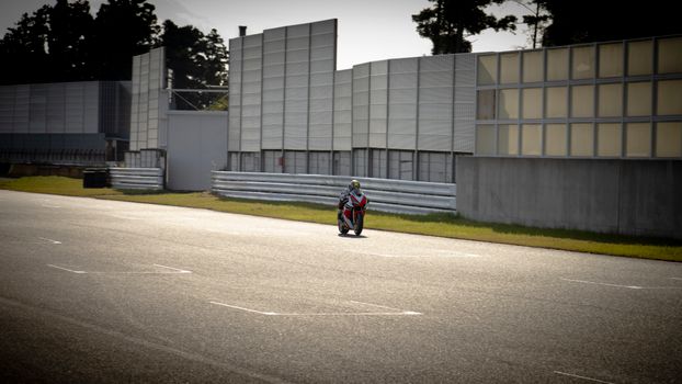 Speeding Motorcyle Hurtling Along Racetrack