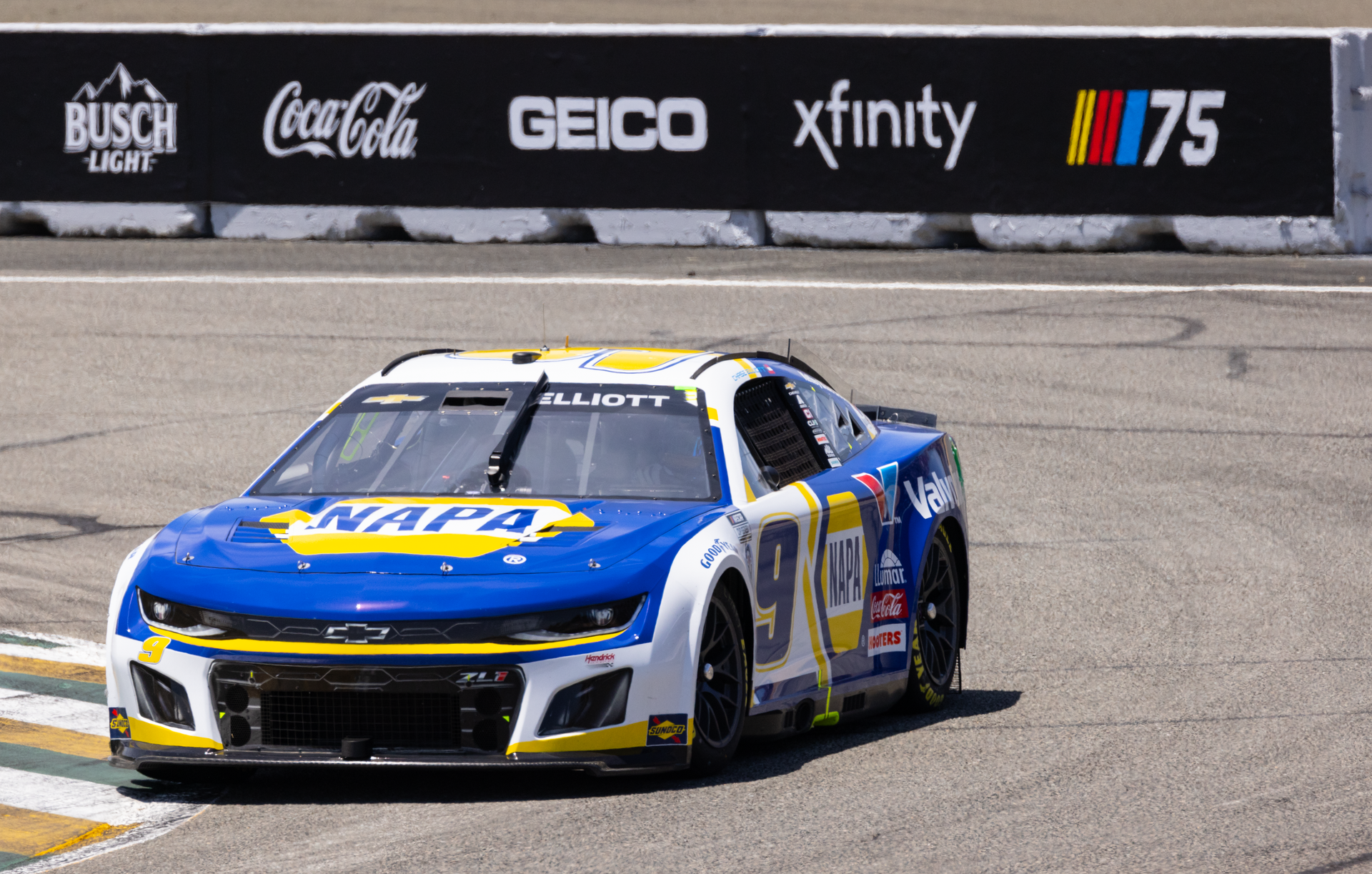 Photo of a Race Car on a Track, and Logos in Background