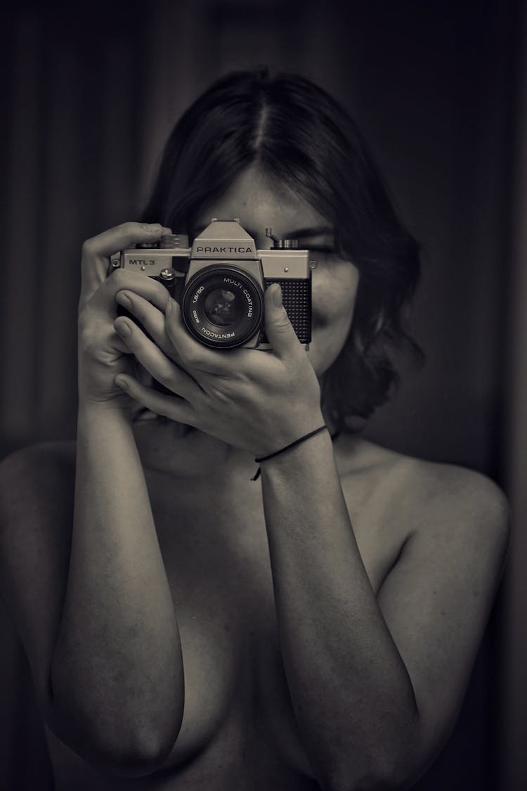 Naked Woman Looking Through The Camera Lens