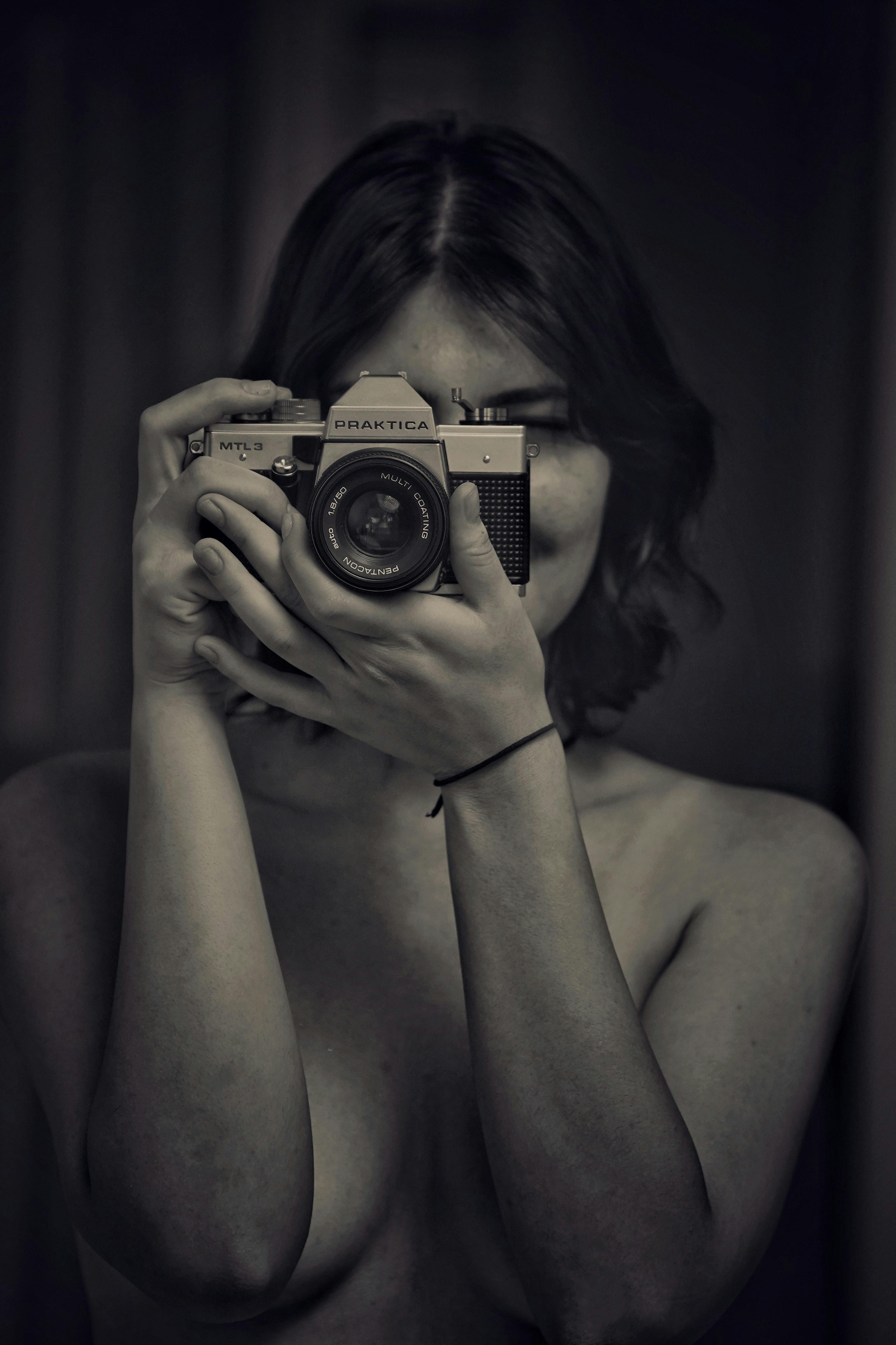 Naked Woman Looking Through the Camera Lens · Free Stock Photo