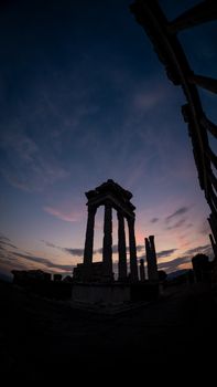 Stunning silhouette of ancient temple ruins at twilight in İzmir, Türkiye.