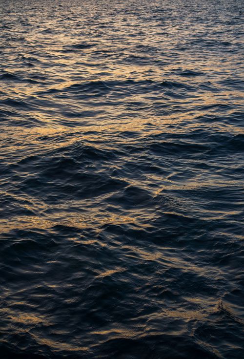 Free Golden sunset light reflecting on the wavy Aegean sea waters in İzmir, Türkiye. Stock Photo