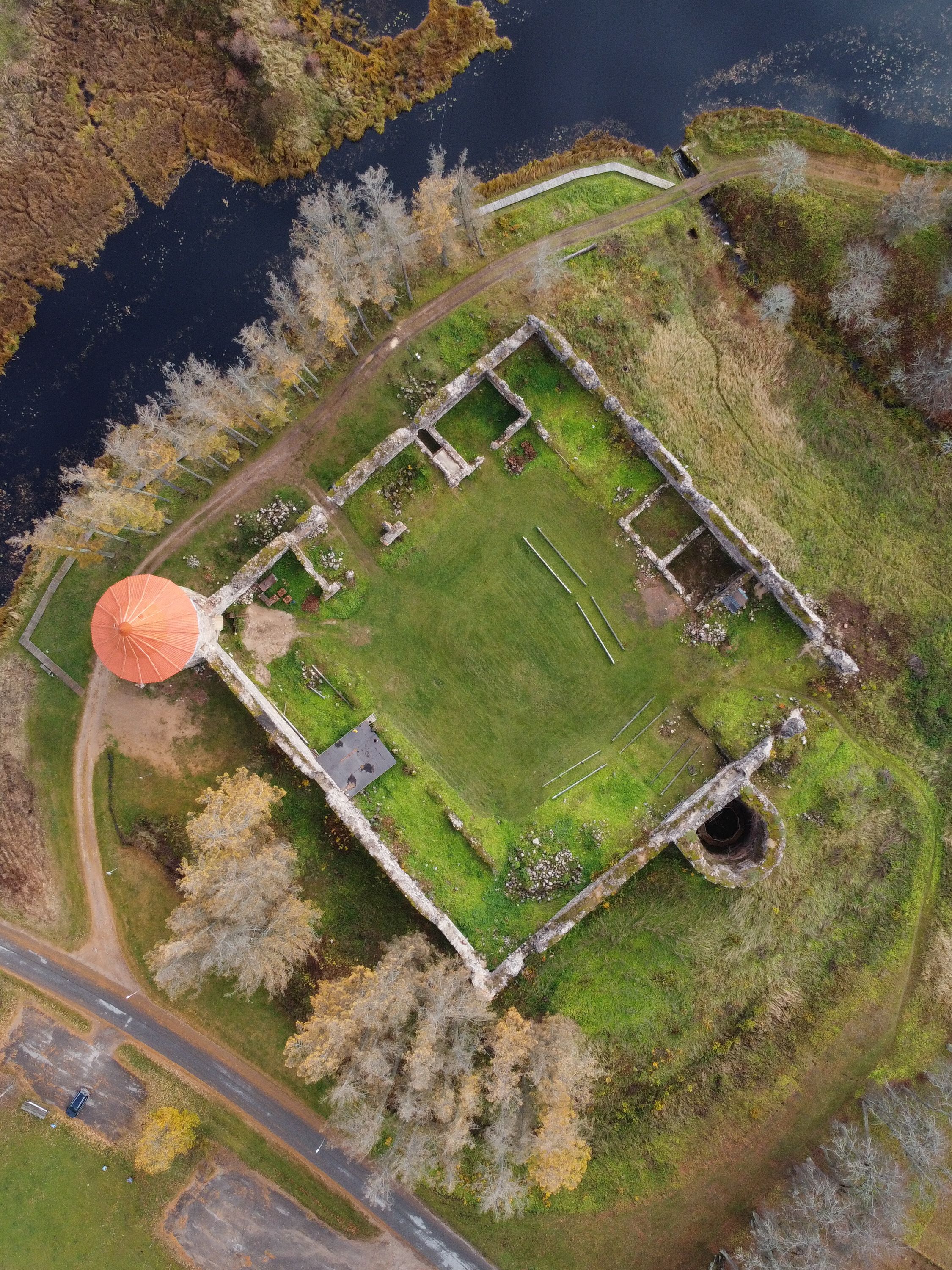 Breathtaking aerial shot of ancient castle ruins surrounded by nature.