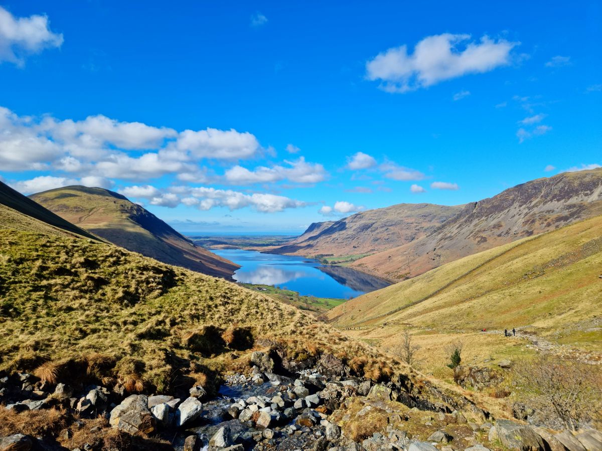 Looking down the length of Wast Water between steep fells on a clear day.