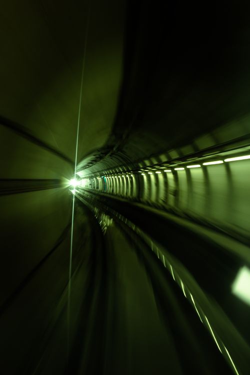 Free Green-lit subway tunnel depicting speed and motion. Captivating abstract image. Stock Photo