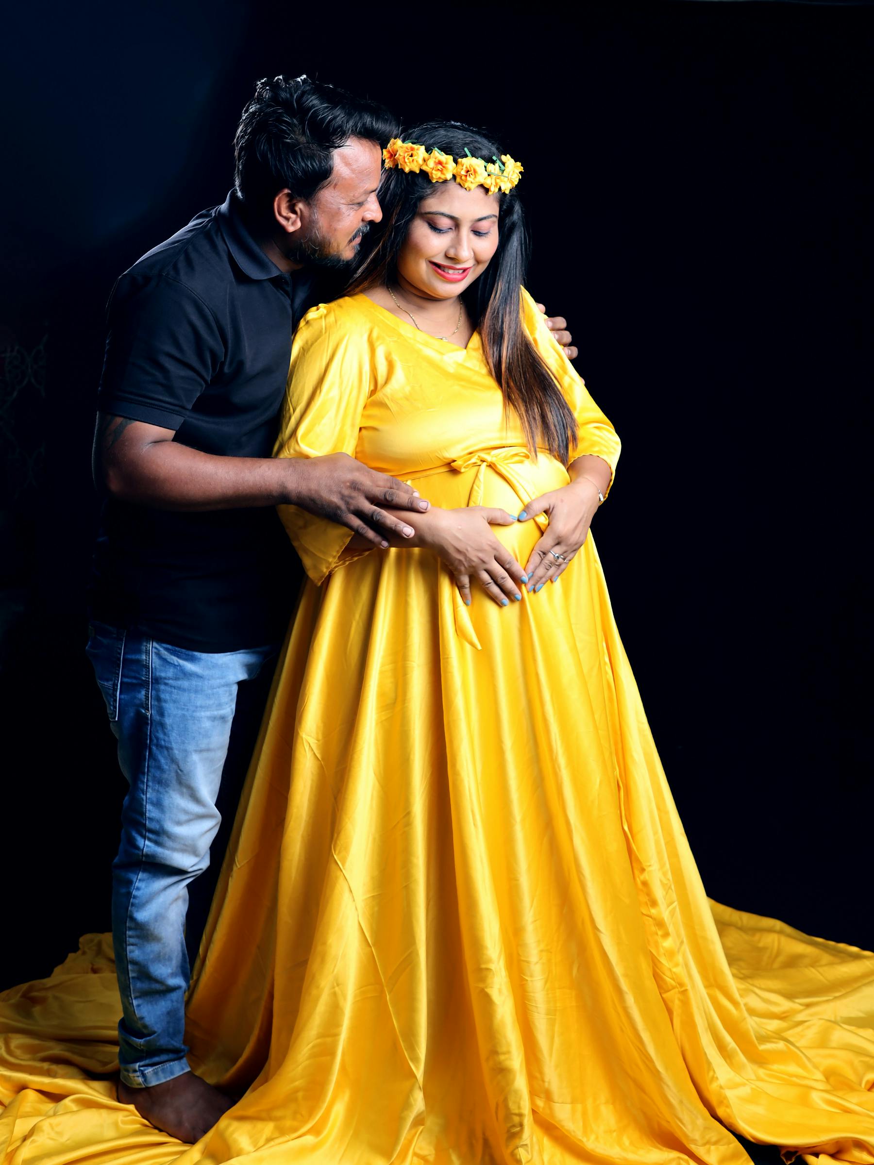 couple pose for maternity photoshoot