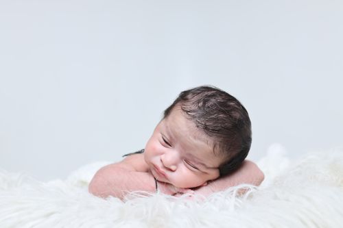 Free Charming portrait of a sleeping newborn baby on a soft white blanket, radiating innocence and serenity. Stock Photo