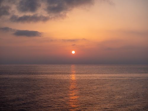 Free Beautiful sunset over the Ligurian Sea in Genoa, Italy with calm ocean and vibrant sky. Stock Photo