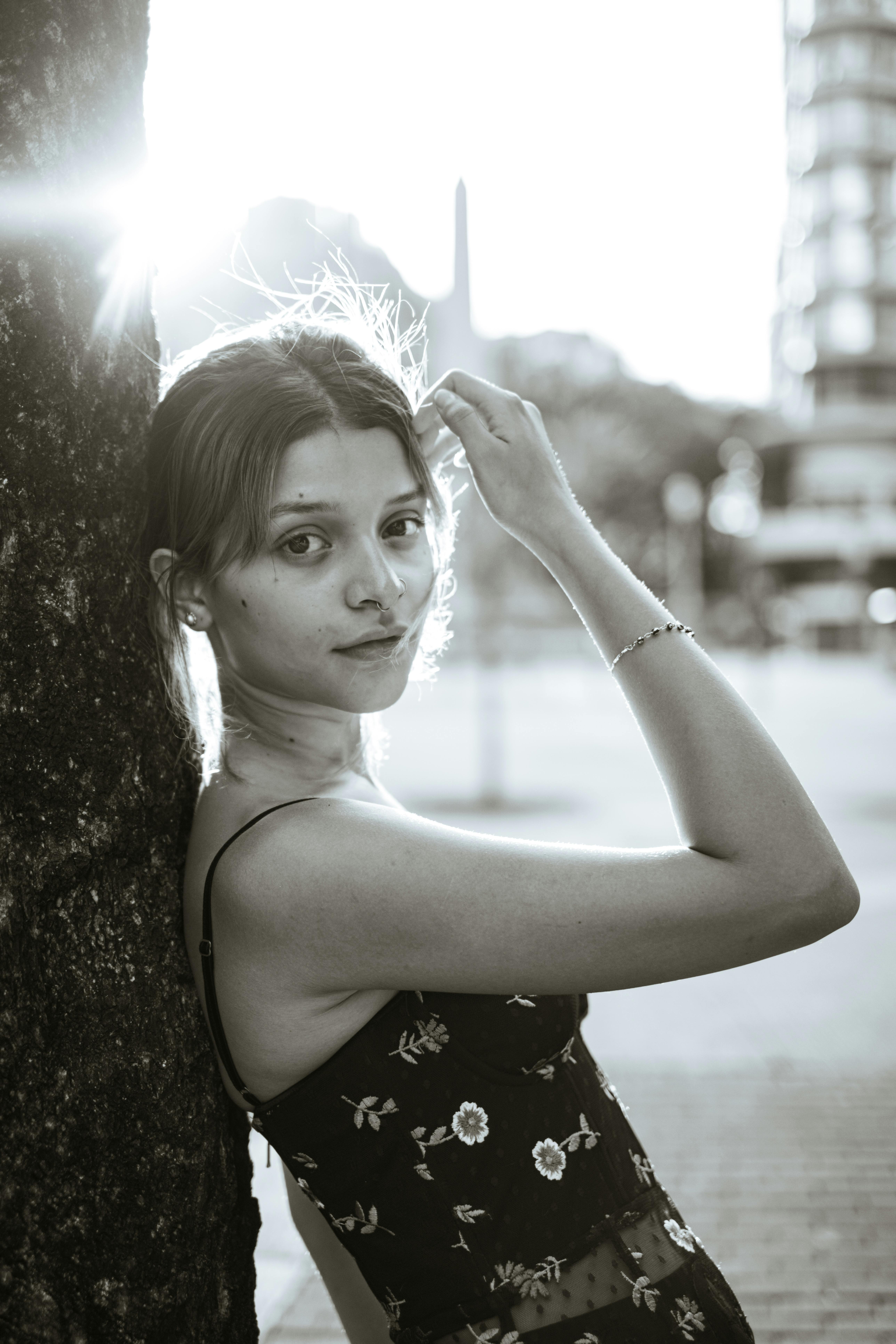 Backlit portrait of a woman leaning against a tree in Belo Horizonte, Brazil.