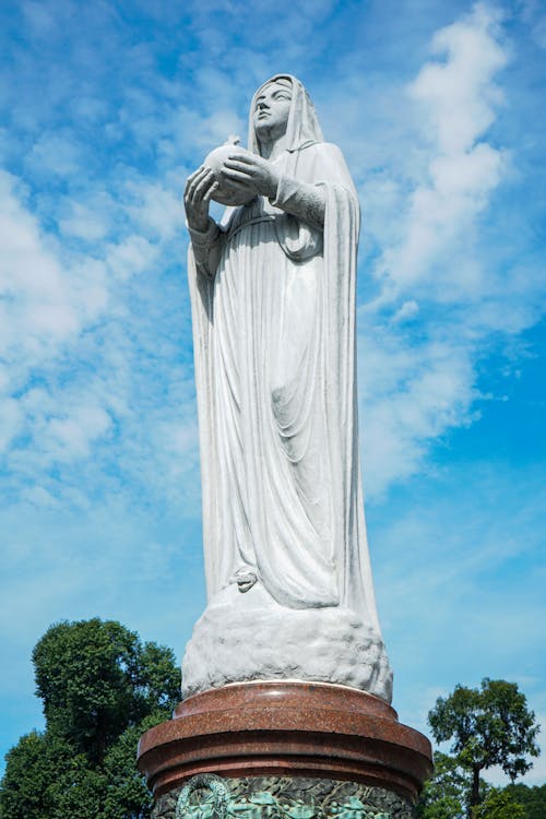 Stone Statue of Virgin Mary who Holds Ball