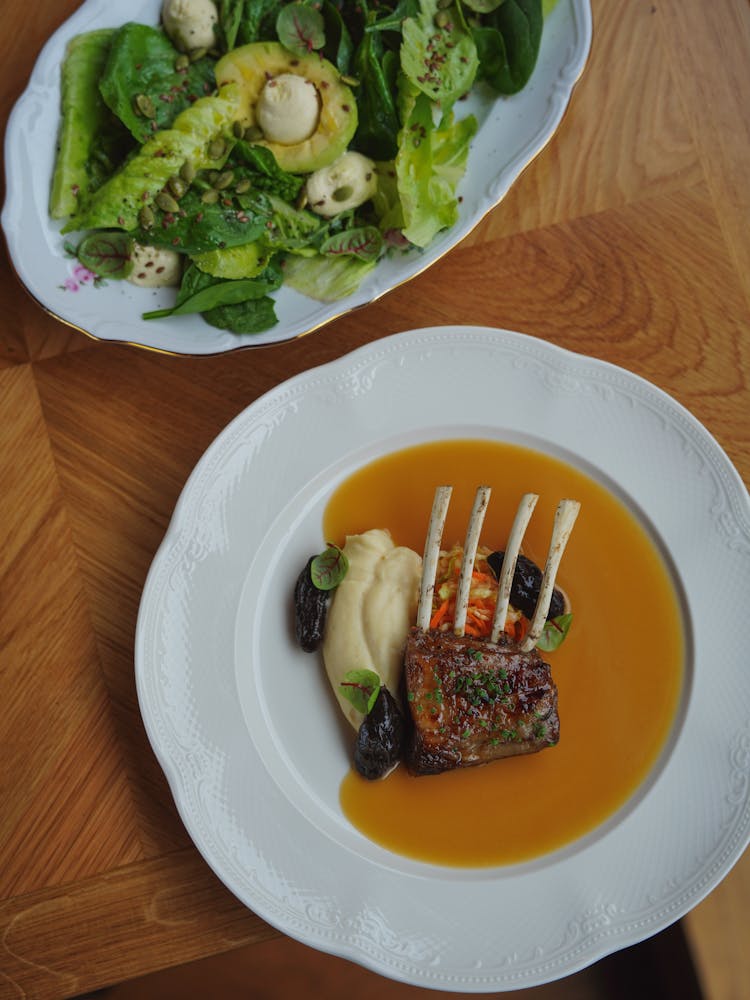 Ribs Served In Sauce On White Plate