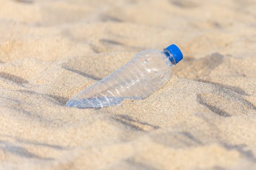 Empty Plastic Bottle in Sand