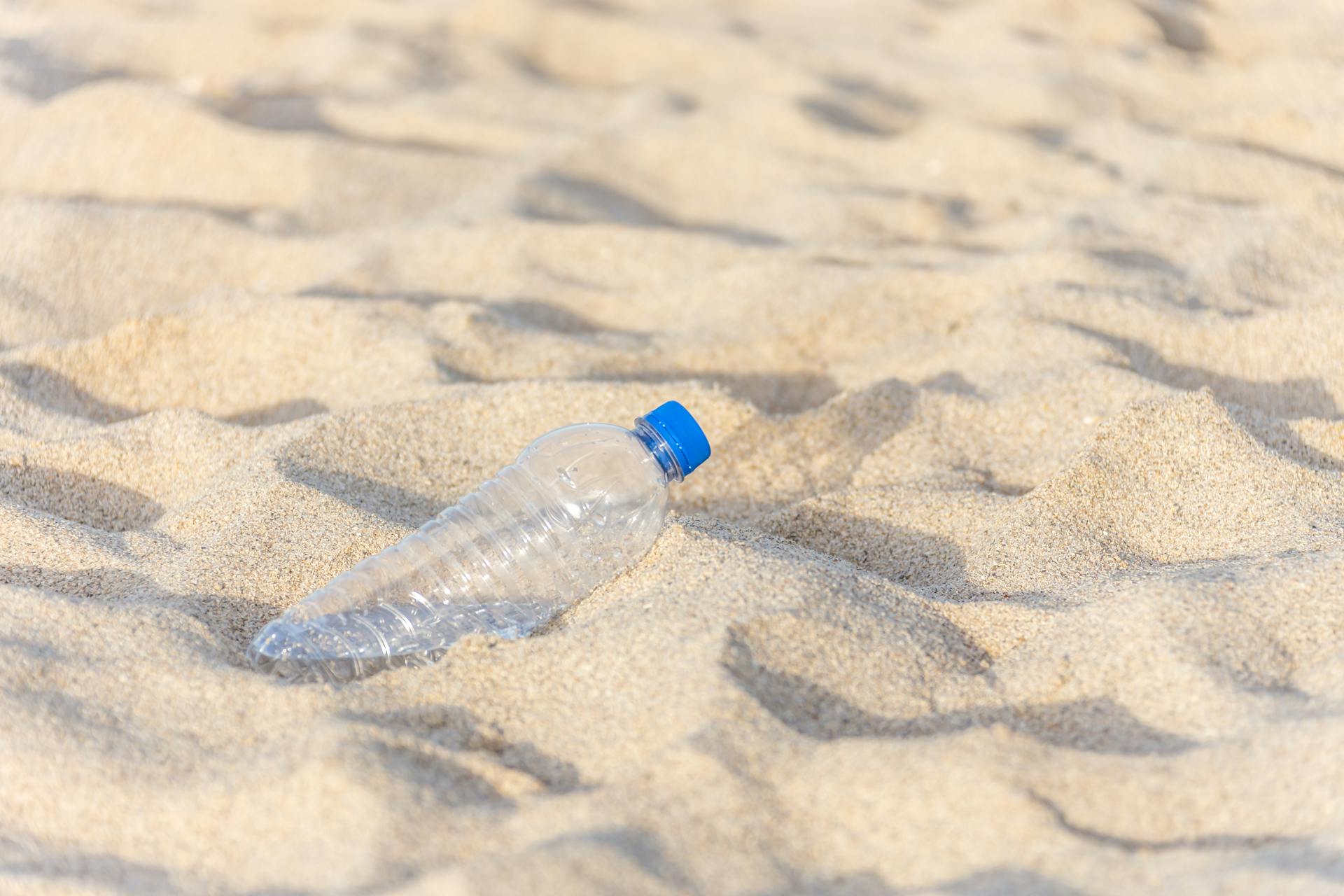 Plastic Bottle Buried in Sand