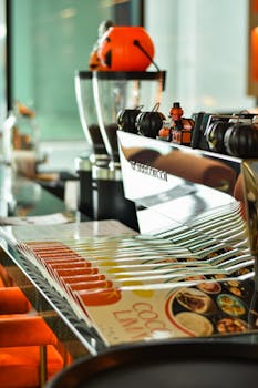Close-up of a modern coffee shop counter with an espresso machine and colorful menus.