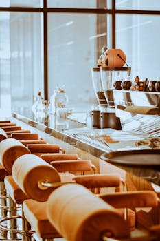 Cozy café interior featuring counter seating and an espresso machine, perfect for a coffee break.