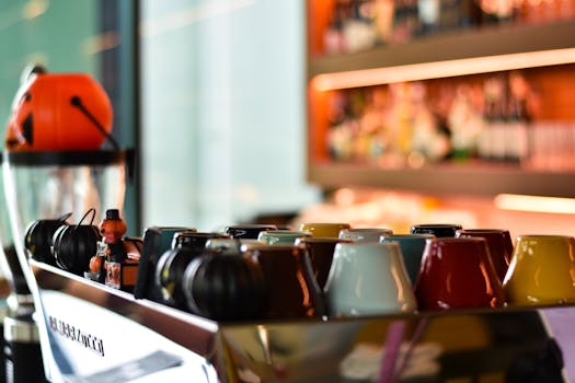 Vibrant coffee cups on an espresso machine, adding charm to a modern café setting.